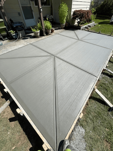 Retractable gray pergola shade structure installed over residential patio area