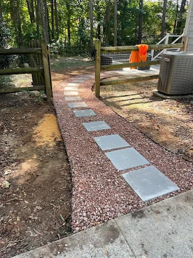 Outdoor backyard patio area with stepping stone pathway through wooded landscape setting